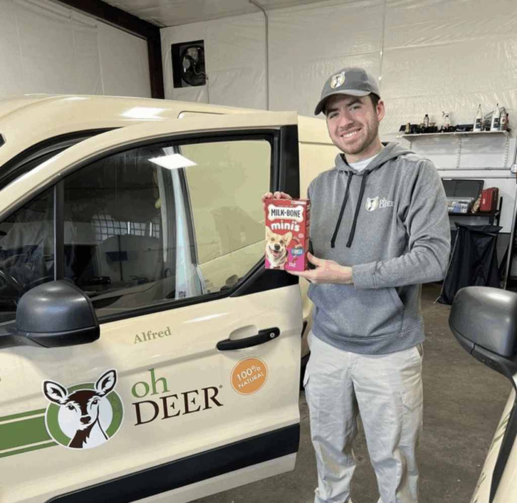 Technician Kaleb holding dog treats