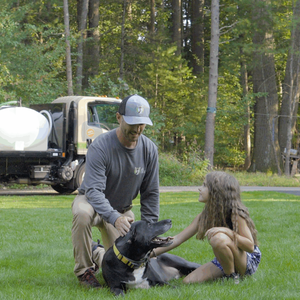 ohDEER owner petting dog with kid in yard 