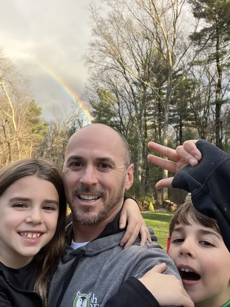 Bob Gaska selfie with kids in front of rainbow 