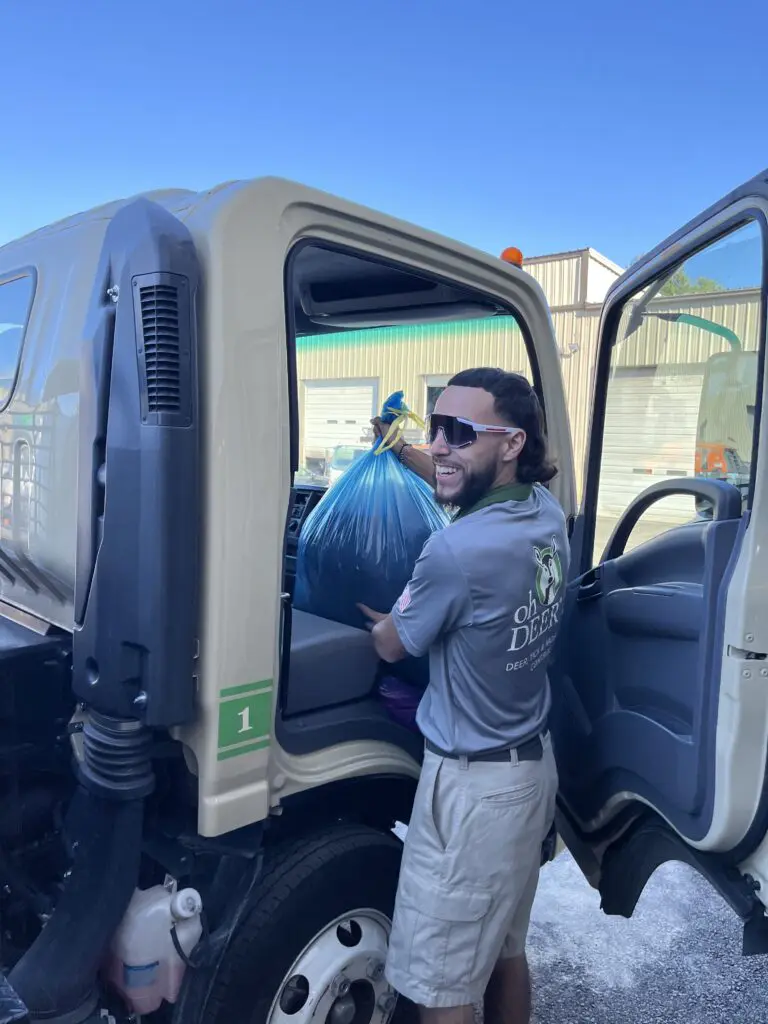 ohDEER technician putting coat drive coats in his spray truck 