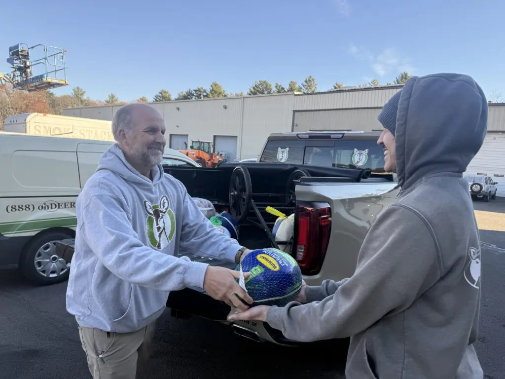 ohDEER founder giving tukey to ohDEER Metro West technician 