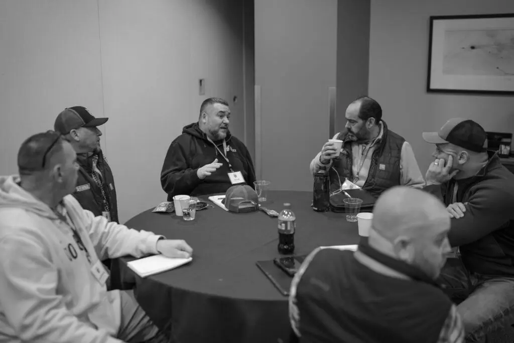 jay lodi and rich harris talking at table