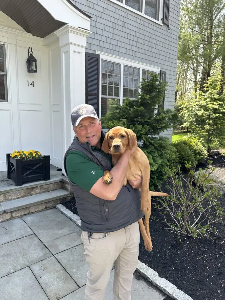 ohDEER founder Kurt Upham holding a customer's puppy 