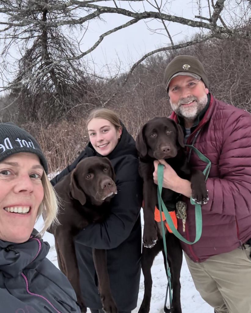 Kurt and Colleen Upham with daughter and dogs in snow 