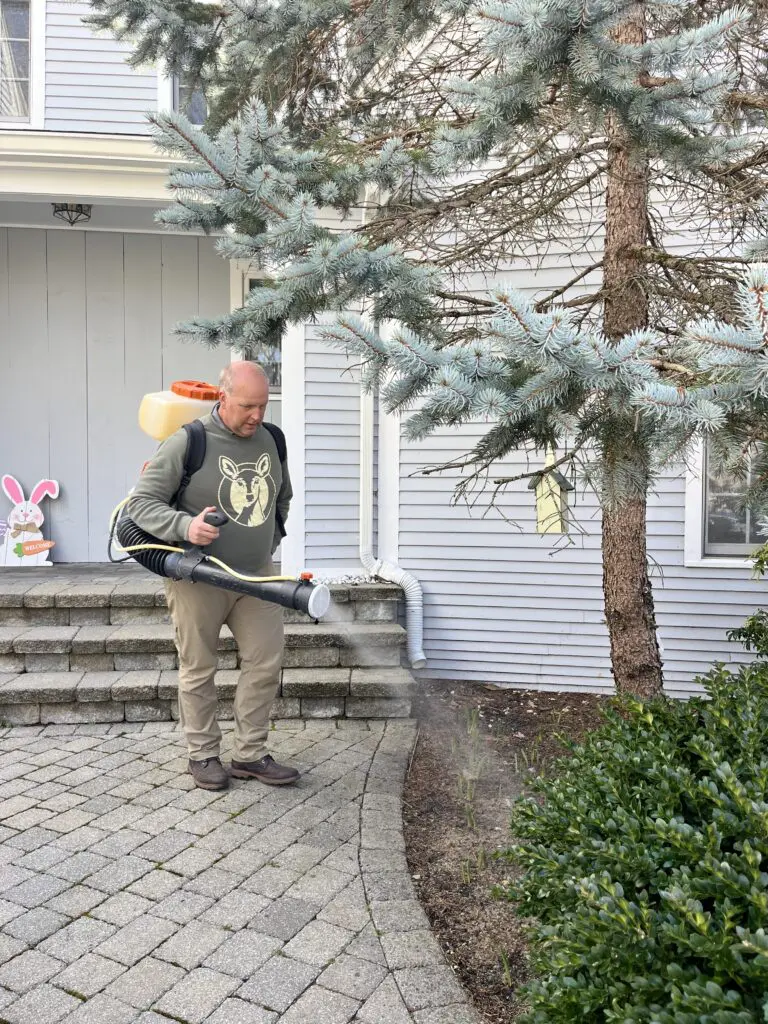 kurt upham spraying deer control in customer's yard 