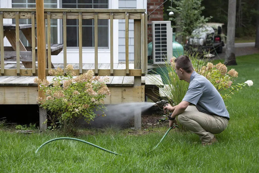 ohDEER technician spraying under deck 