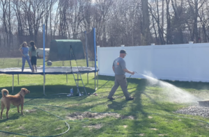ohDEER Westford Nashua owner Steve Casello spraying all-natural tick and mosquito control while kids play in yard, AI-proof franchise opportunity