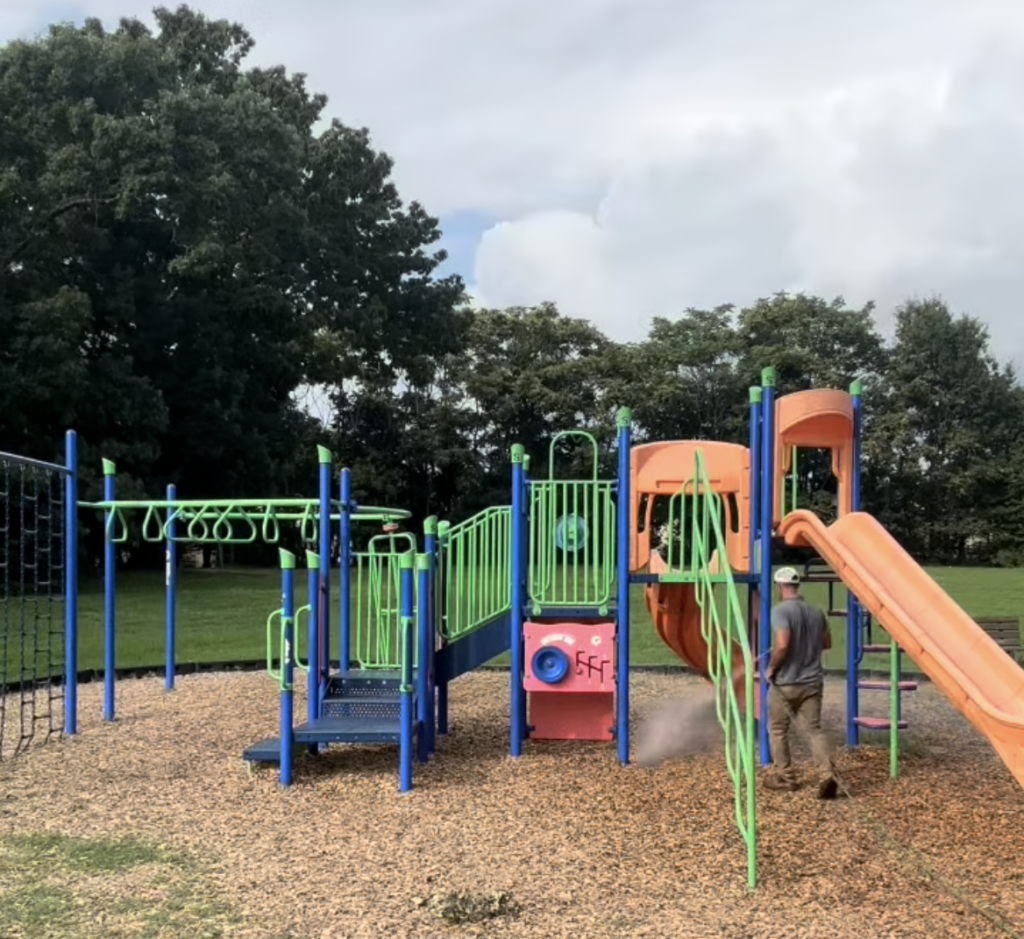 josh hafner spraying all natural tick and mosquito control around kids play equiptment