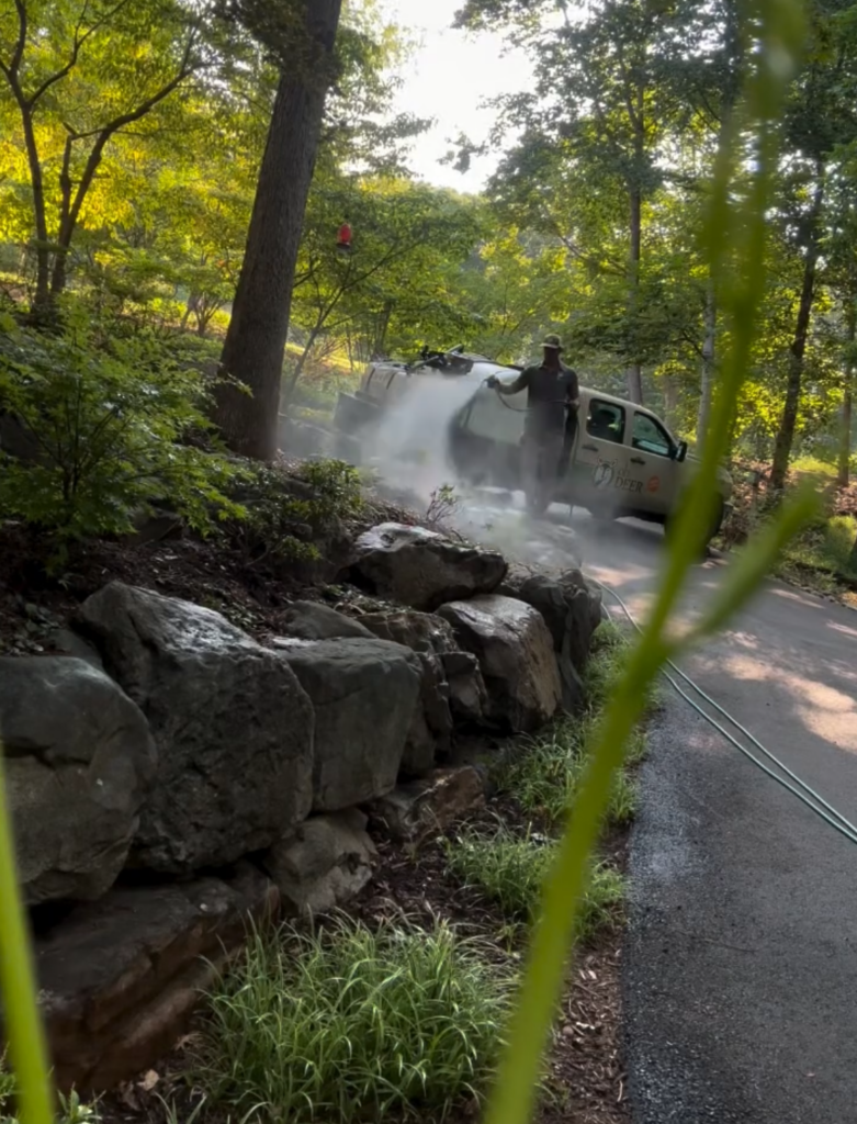 all natural pest control virginia ohdeer central va owner josh hafner spraying all-natural tick and mosquito control on customer's property