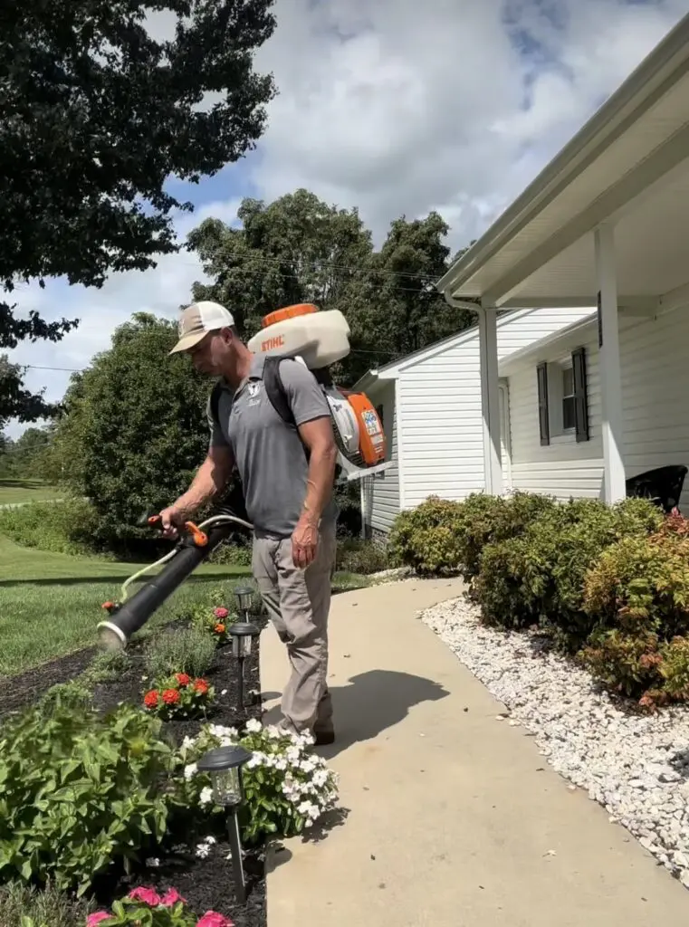 josh hafner spraying all natural deer control in customers front yard