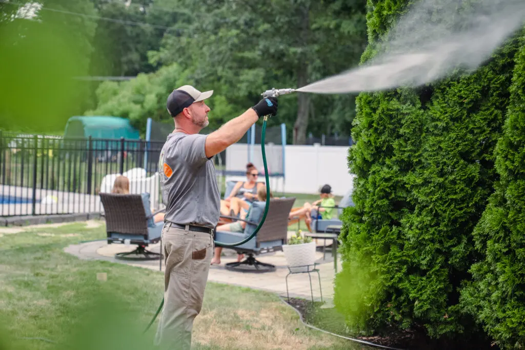 outdoor franchise opportunities ohDEER spraying with family hanging out by firepit and pool